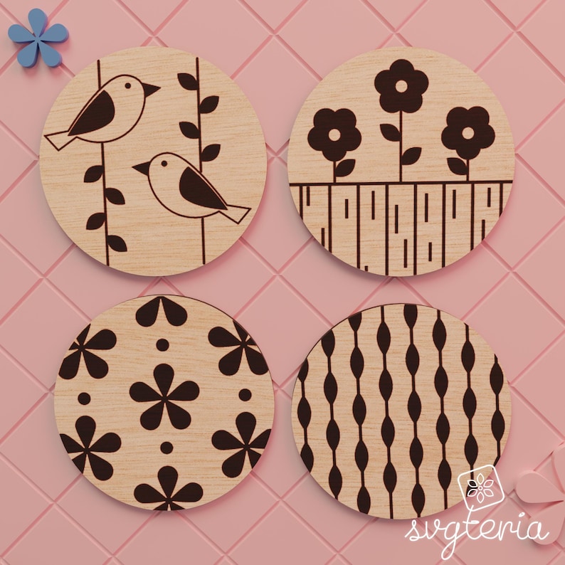 May include: Four round wooden coasters with engraved designs. One coaster features two birds on a branch, another has flowers, a third has a floral pattern, and the last has an oval pattern. The coasters are light brown.