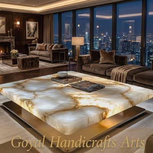 May include: A contemporary living room with a striking coffee table. The table has a white and gold marble-effect surface, illuminated from within, and a gold base. Brown sofas, a fireplace, and large windows with a city view complete the scene.