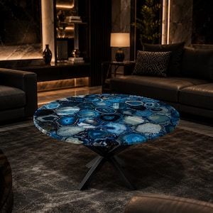 Handmade round blue agate coffee table featuring vibrant gemstone slices and a modern black metal base for luxury interiors.
Natural blue agate centerpiece table showcasing unique crystal formations and elegant contemporary craftsmanship.