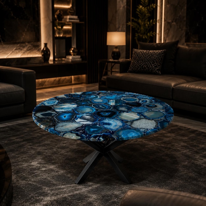 Handmade round blue agate coffee table featuring vibrant gemstone slices and a modern black metal base for luxury interiors.
Natural blue agate centerpiece table showcasing unique crystal formations and elegant contemporary craftsmanship.