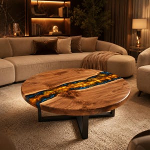 May include: A round coffee table featuring a natural wood slab with a prominent live edge and a central river-like inlay of translucent blue and amber resin. The table is supported by a black metal base with intersecting legs.