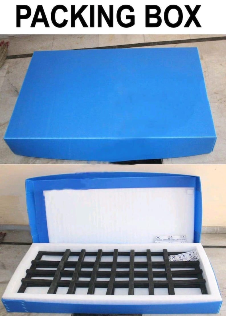 May include: Blue packing box with the text "PACKING BOX" at the top. The box is shown closed and open, revealing white foam padding and a black grid-like structure inside. The box is made of a durable material.