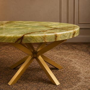 Artisan crafted green gemstone surface with unique earthy markings and refined detailing
Statement round stone centerpiece displayed in an upscale neutral home setting
