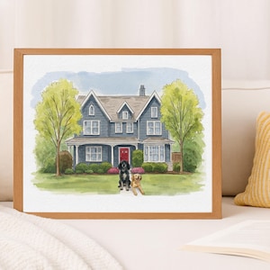 May include: A watercolour painting in a light wood frame depicting a two-storey blue house with a red front door, a green lawn, and two large trees. A black dog and a golden-coloured dog are sitting together on the grass in front of the house.