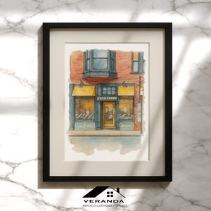 May include: Watercolour painting of a shop front with the text "CASA VERDE" above the door. The building has a red brick facade, a yellow awning, and a black frame. The artwork is a "VERANDA WATERCOLOUR HOUSE PORTRAITS".