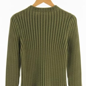 May include: Olive green ribbed knit sweater with long sleeves and a mock neck. The sweater is hanging on a wooden hanger against a white background. The knit pattern creates vertical lines.