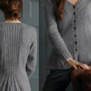 May include: A gray, long-sleeved cardigan sweater with a V-neck and button closure. The back features a cable knit design. The sweater is made of a soft, knitted material. The sleeves have ribbed cuffs. A classic, comfortable garment.