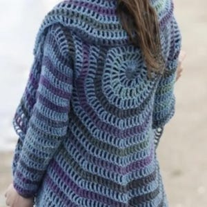 May include: A handmade crochet cardigan in shades of blue, purple, and gray. The open-weave design features a spiral pattern on the back and hood, with striped sleeves. A unique, cozy garment.