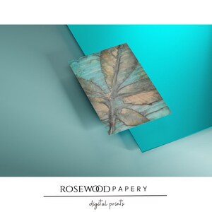 May include: A rectangular digital print featuring a botanical design of brown and tan leaves against a textured turquoise and teal background. The text ROSEWOOD PAPERY and digital prints is centered at the bottom of the image in black font.