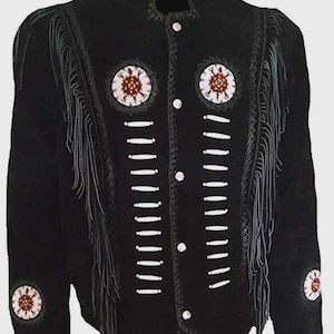 May include: Black suede jacket with white bead accents and fringe detailing. The jacket features decorative circular patches with red and white patterns, white button closures, and a high collar. A unique piece of outerwear.