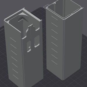 May include: Two gray, rectangular, 3D-printed components. One component has a series of angled slots and cutouts. The other component has a series of angled slots. Both components have a square top opening.