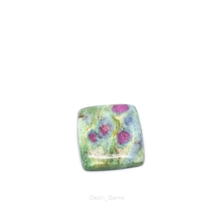 May include: A square-shaped gemstone with a mix of colors. The stone features a light green base with patches of pink and blue. The pink areas are concentrated in the center, while the blue and green hues are spread throughout the stone.