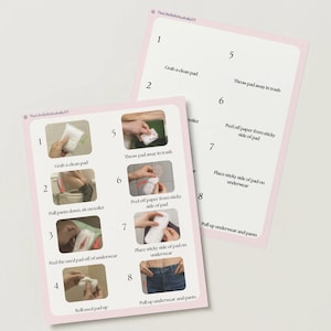 May include: Two pink cards with instructions for using a sanitary pad. The cards have a pink border and white background. The instructions are numbered and include images and text. The text includes the steps: grab a clean pad, pull pants down, sit on toilet, etc.