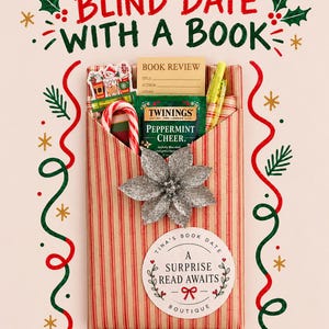 May include: A rectangular package wrapped in red and white striped paper labeled Blind Date With A Book. It contains a Twinings Peppermint Cheer tea bag, a candy cane, a yellow pen, and a book review card, topped with a silver glittery poinsettia.