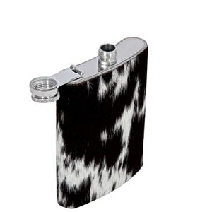 May include: A rectangular metal flask featuring a black and white cowhide pattern on the exterior. The flask has a silver-colored metal top with a hinged screw cap that is currently open, revealing the threaded opening and the metallic finish.