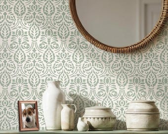 May include: A wall stencil featuring a repeating sage green damask pattern on a cream background. The design consists of symmetrical floral and leaf motifs arranged in a vertical, interconnected layout, creating a continuous wallpaper effect.