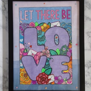 May include: A framed art print featuring the text LET THERE BE LOVE in large purple letters. The design includes colorful hand-drawn floral patterns, swirling shapes, and small envelope icons in shades of pink, orange, blue, and green, all enclosed within a simple black frame.