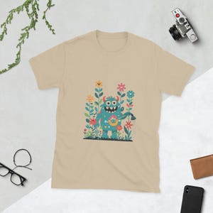 Monstrous Delight – Colorful Cartoon Monster Watering Flowers T-Shirt