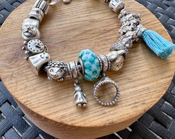 Authentic Pandora Silver Bracelet 76g w/assorted pandora charms.