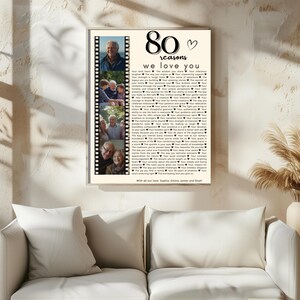 May include: A framed print with the text "80 reasons we love you" and a heart symbol. It includes a filmstrip of family photos. The bottom of the print reads "With all our love: Sophia, Emma, James and Noah."