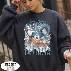 A woman wearing a gray sweatshirt with a graphic of Mickey Mouse and the text "Walt Disney's Fanta" printed on it.