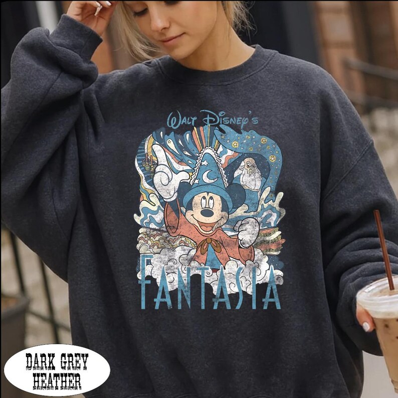 A woman wearing a gray sweatshirt with a graphic of Mickey Mouse and the text "Walt Disney's Fanta" printed on it.