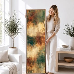 May include: A tall, rectangular vertical canvas wall art piece featuring an abstract painting with blended layers of deep forest green, warm burnt orange, and golden yellow tones, encased in a thin, light-colored wooden frame.