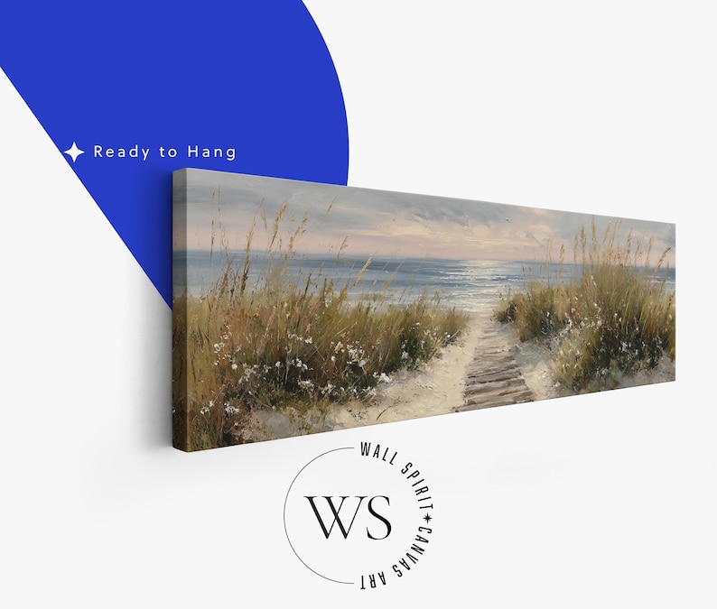 May include: A panoramic canvas print featuring a coastal landscape with a sandy path leading through tall dune grasses toward the ocean at sunset. The sky is painted in soft muted tones of blue and grey. The text Ready to Hang is visible.