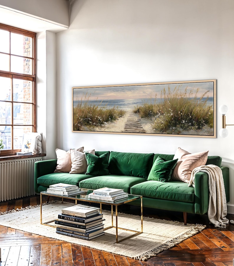 May include: A long, rectangular landscape painting in a light wood frame depicting a sandy beach path leading toward the ocean. The scene features tall dune grasses, soft blue water, and a pale sky, capturing a serene coastal view in a wide format.