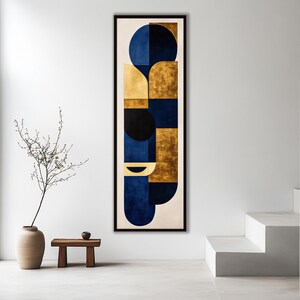 May include: A tall, rectangular framed wall art piece featuring a vertical composition of geometric shapes. The design incorporates deep blue, black, and metallic gold blocks and circular segments arranged against a neutral off-white background.