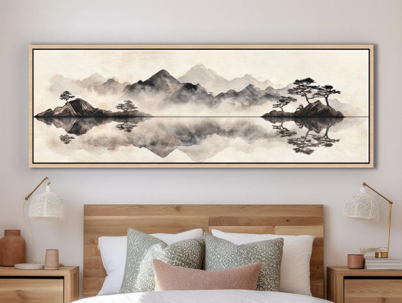 May include: A long, rectangular framed canvas art piece depicting a serene landscape. The artwork features a monochromatic scene of mountains, water, and trees, with reflections in the water. The color palette is primarily black, white, and gray.