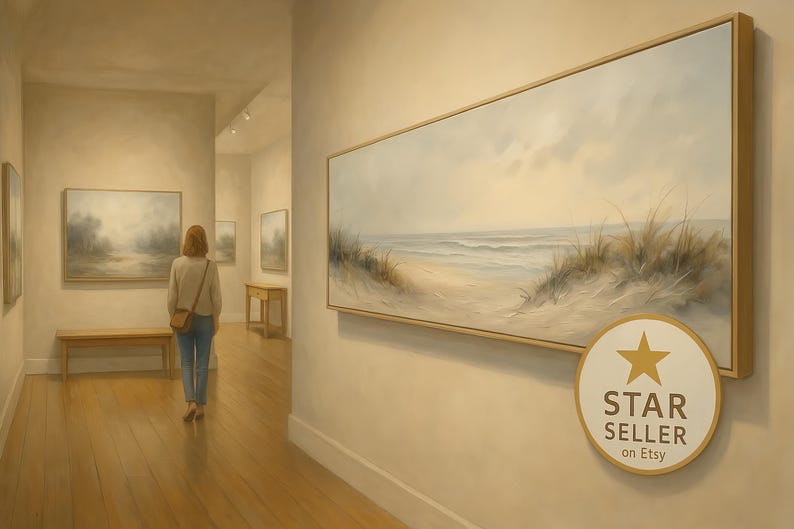May include: An art gallery interior featuring a woman viewing a large framed landscape painting of a beach scene. The painting has a neutral color palette with a sandy beach, ocean waves, and tall grasses. The gallery has light-colored walls and wooden floors.