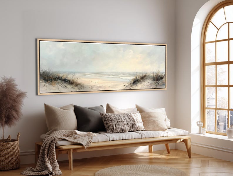 This panoramic beach artwork captures the peaceful moment of stepping through soft sand dunes and looking out toward the endless horizon. Gentle waves meet the sky in muted tones, creating a soothing balance of light and texture. It’s the perfect piece to bring calm, natural elegance, and timeless coastal charm into your space.