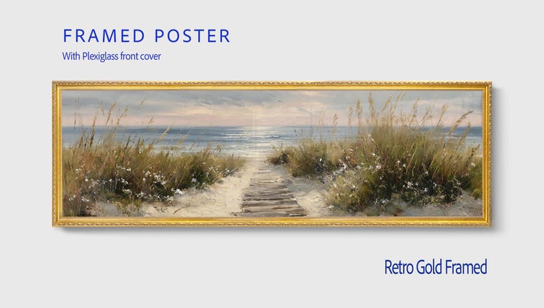 May include: A panoramic framed poster featuring a coastal landscape with a wooden boardwalk leading through sand dunes toward the ocean. The artwork is enclosed in a textured retro gold frame and includes a clear plexiglass front cover for protection.