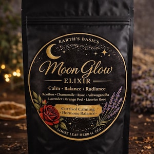 May include: Black pouch of Moon Glow Elixir loose leaf herbal tea. The label features a crescent moon, stars, and a rose. Ingredients include rooibos, chamomile, rose, and lavender.