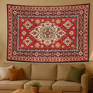 May include: A large, rectangular red tapestry with an intricate floral design hangs above a beige sofa. The tapestry features a central medallion and a detailed border. The room includes a wooden coffee table, a lamp, and potted plants.