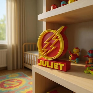 May include: A red and yellow decorative sign with the name "JULIET" in yellow block letters. The sign features a yellow lightning bolt design inside a red circle. The sign is displayed on a wooden shelf with other toys.