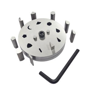 Peut inclure: Un outil de fabrication de bijoux en métal argenté avec diverses découpes de formes et plusieurs poinçons métalliques de différentes formes géométriques. Une clé hexagonale noire est incluse. L'outil est conçu pour découper des formes dans du métal ou d'autres matériaux.