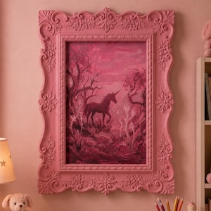 May include: A pink framed painting of a unicorn in a forest scene. The painting is in a pink ornate frame. The room is decorated in shades of pink, with a teddy bear, lamp, and pencils visible.