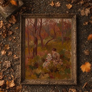 May include: An antique framed painting depicting a woman and child in a forest setting. The artwork features warm tones of brown, red, and green, with a detailed gold frame. The painting is surrounded by fallen autumn leaves.