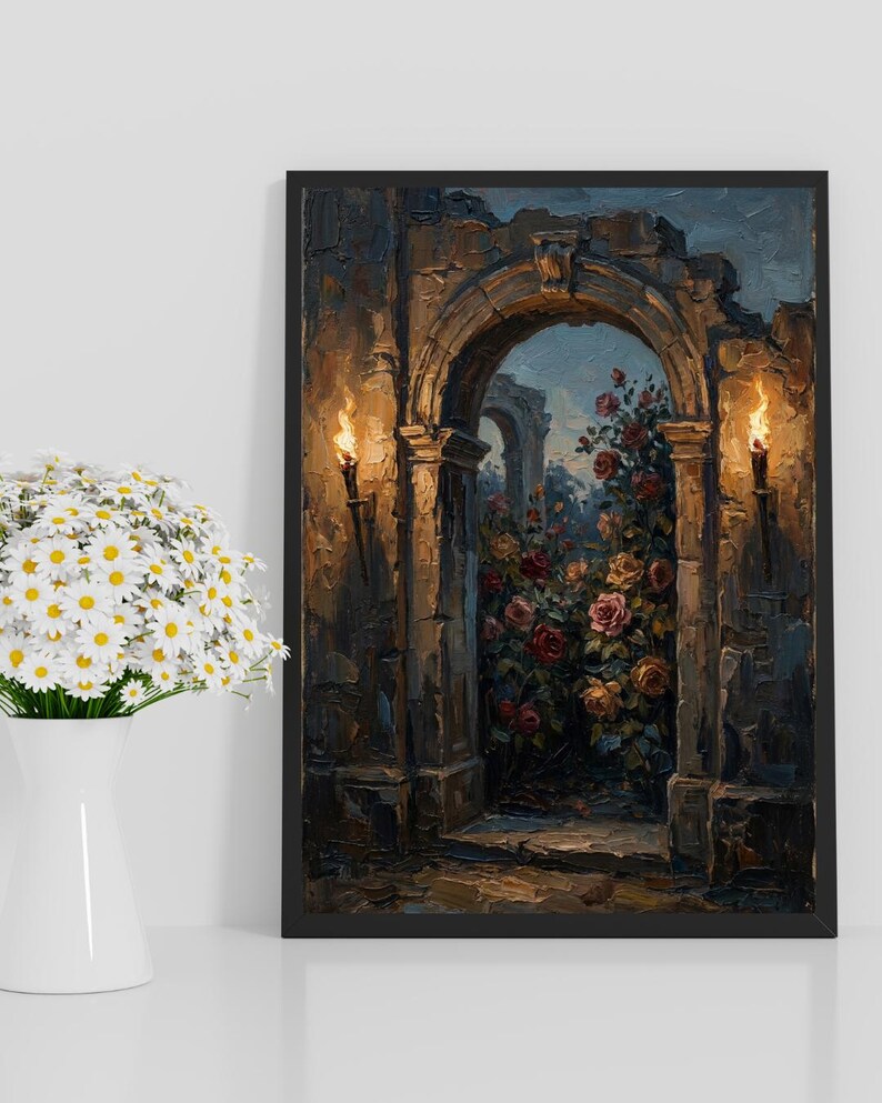 May include: Oil painting in a black frame, showing an arched stone doorway with torches and a rose garden. The artwork uses a dark, warm colour palette. It is displayed on a white surface, next to a vase of daisies.