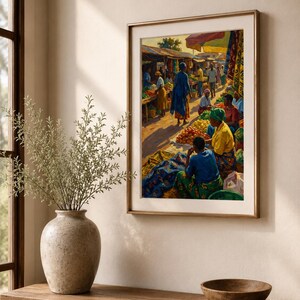 May include: A framed art print showing a bustling market scene. People in bright clothes are at stalls selling produce. The artwork is in a gold frame and hangs on a beige wall. A wooden table with a vase and bowl is in the foreground.