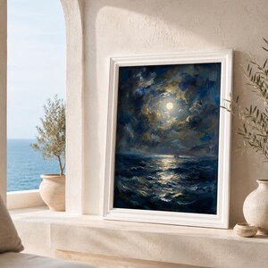 May include: A framed oil painting depicts a moonlit seascape. The artwork features a dark blue ocean with white-capped waves reflecting the moon's light. The sky is filled with swirling clouds, and the painting is set in a white frame.