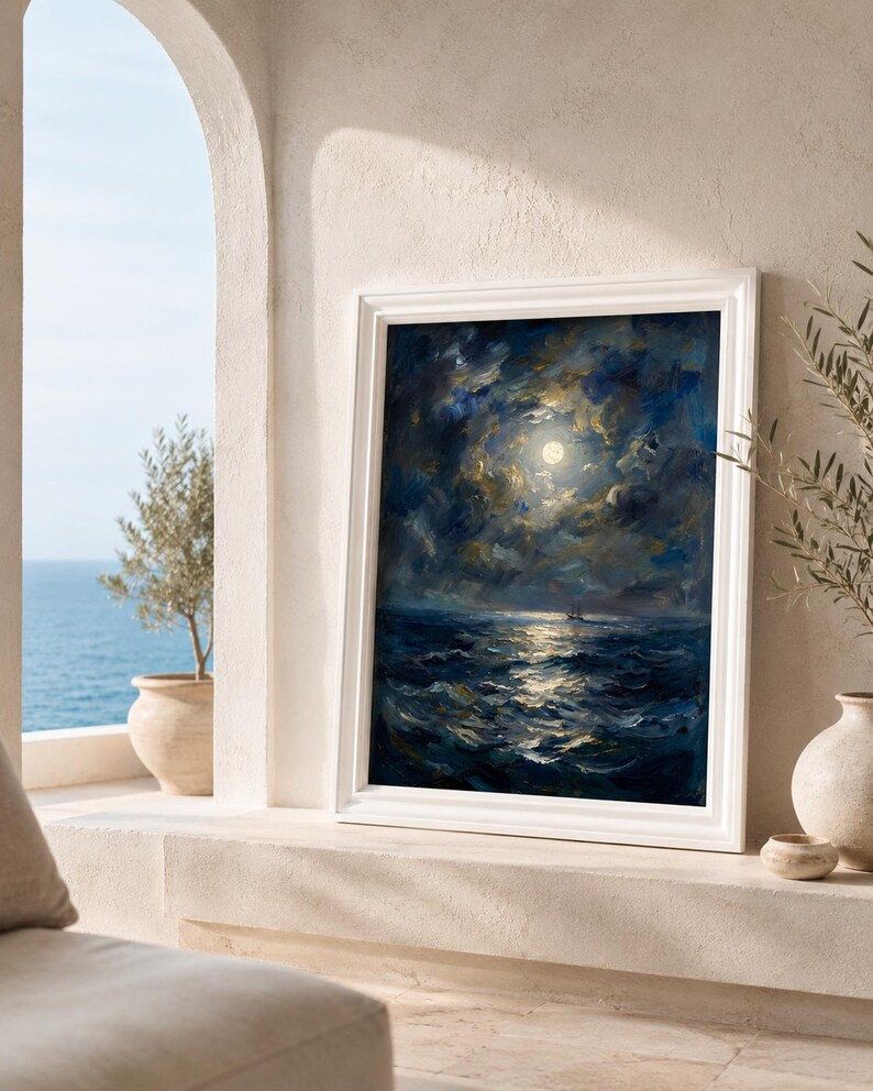 May include: A framed oil painting depicts a moonlit seascape. The artwork features a dark blue ocean with white-capped waves reflecting the moon's light. The sky is filled with swirling clouds, and the painting is set in a white frame.