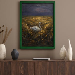 May include: Oil painting of a white swan in a field of golden wheat under a dark, stormy sky. The artwork is framed in a vibrant green, displayed above a wooden cabinet with decorative vases.