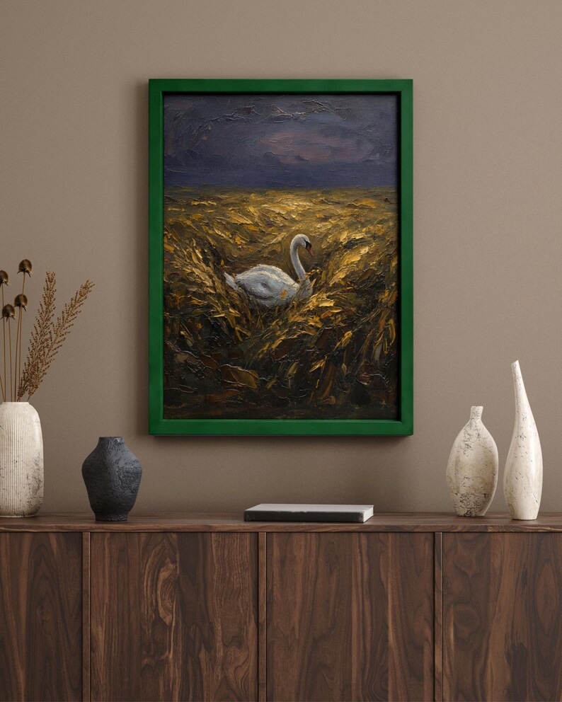 May include: Oil painting of a white swan in a field of golden wheat under a dark, stormy sky. The artwork is framed in a vibrant green, displayed above a wooden cabinet with decorative vases.