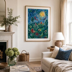 May include: A colourful framed artwork hangs above a white sofa in a living room. The artwork depicts a surreal landscape with a bright sun, figures, and flowers. A coffee table with books and a vase of flowers sits in front of the sofa.