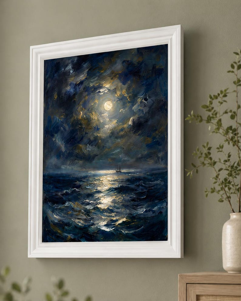May include: Oil painting of a moonlit seascape in a white frame. The artwork depicts a dark blue ocean under a cloudy sky, with a bright full moon and a small sailboat. The brushstrokes create a textured, dynamic feel.