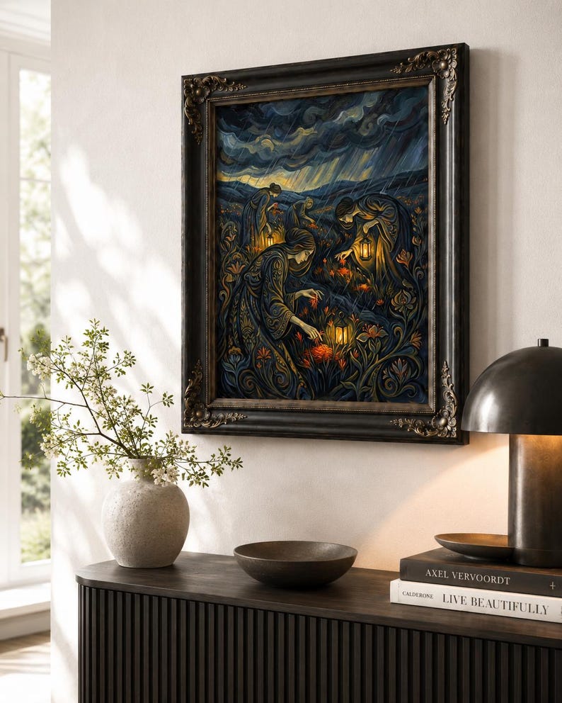 May include: A framed artwork depicts figures in ornate gowns tending to glowing flowers under a stormy sky. The painting, in shades of blue, gold, and orange, is set in a dark, ornate frame. The artwork hangs above a dark wooden cabinet with a vase and a bowl.