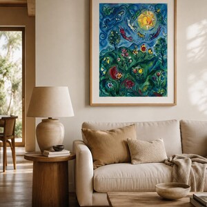 May include: A framed artwork depicting a colourful landscape scene. The painting shows a bright yellow sun, figures, flowers, and trees against a blue backdrop. The artwork is displayed above a beige sofa with brown cushions and a wooden coffee table.